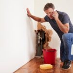 Man With A Burst Water Pipe Phoning