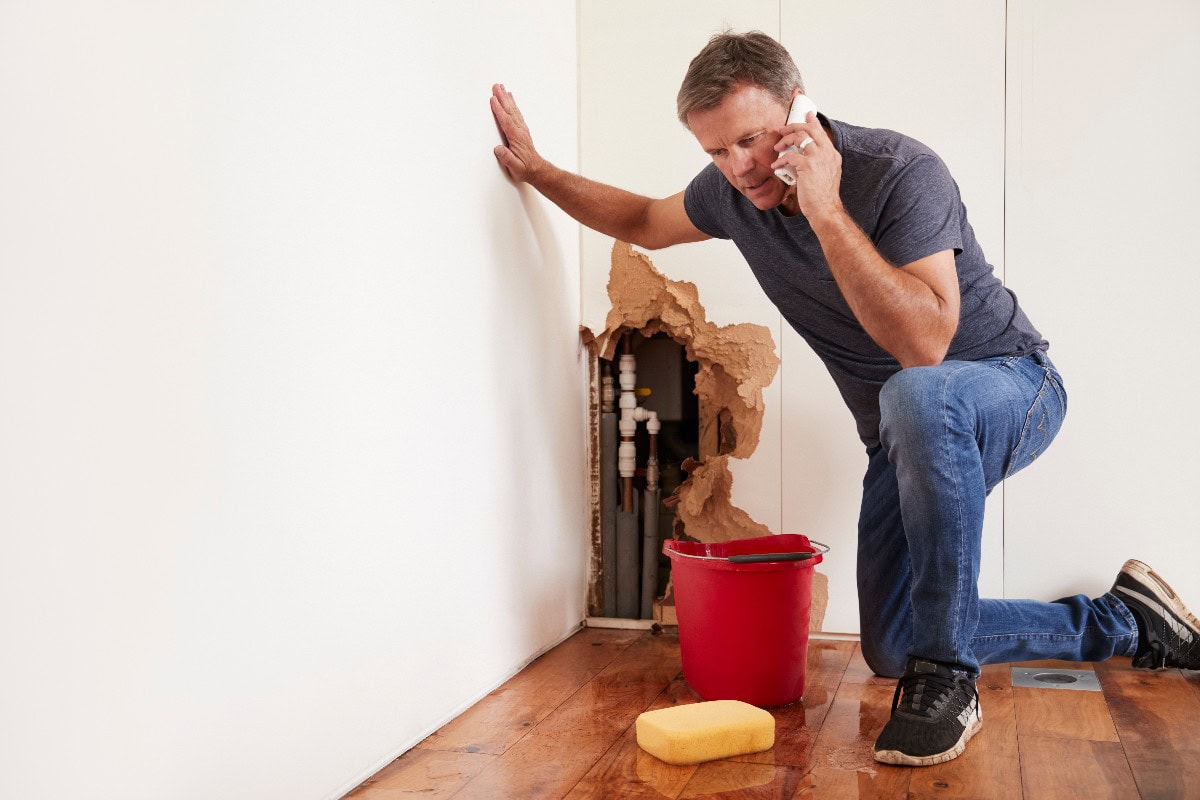 Man With A Burst Water Pipe Phoning