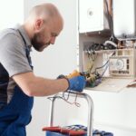 Plumber Servicing Gas Boiler Control Board