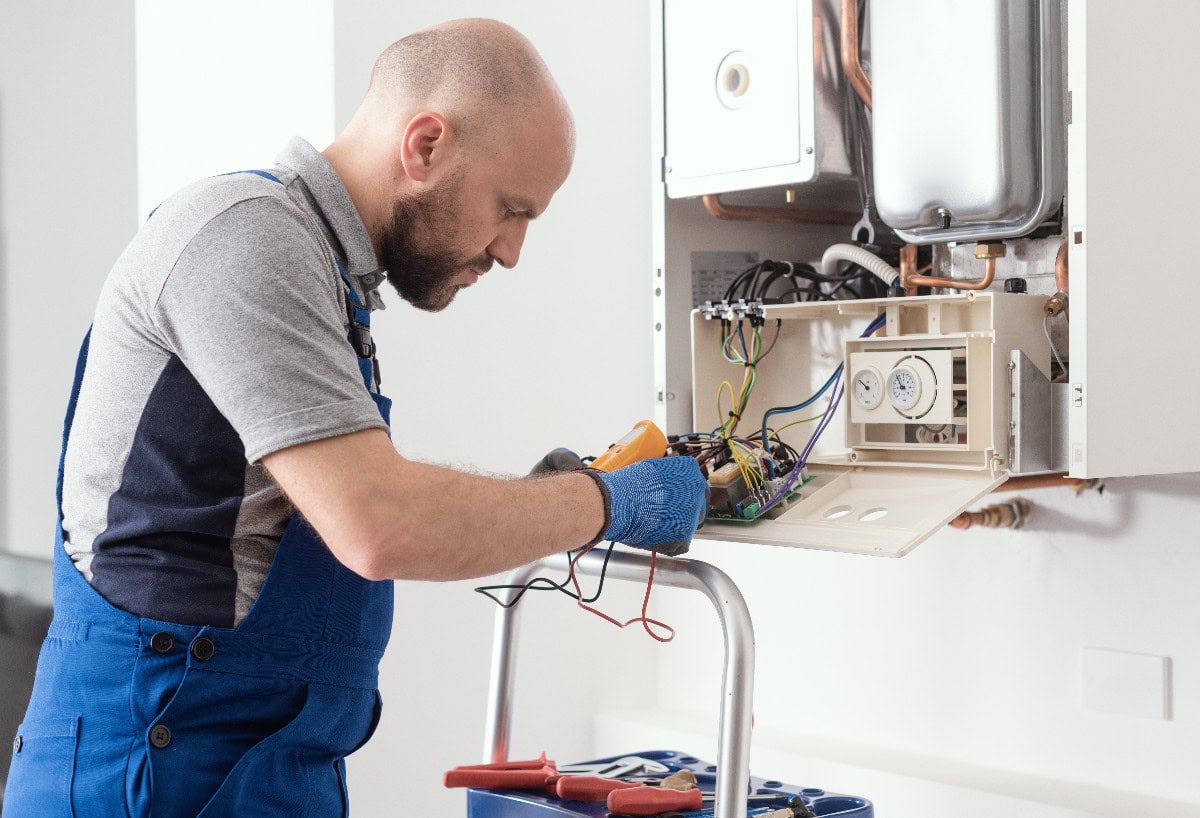 Plumber Servicing Gas Boiler Control Board